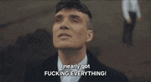 a man in a suit and tie is saying i nearly got fucking everything