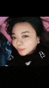 a close up of a woman 's face with a shadow of a mickey mouse on her shirt