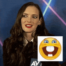 a woman is smiling next to a picture of a smiley face with a missing tooth