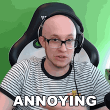a bald man wearing glasses and headphones says annoying while sitting in a chair