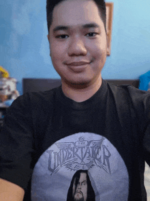 a man wearing a t-shirt that says the undertaker