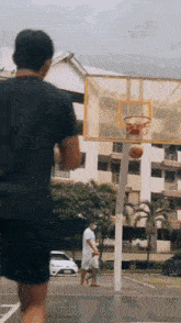 a man wearing a mask is playing basketball in a parking lot