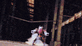 a person in a robot costume stands in a dark building