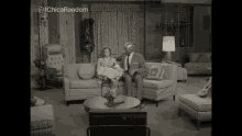 a man and a woman are sitting on a couch in a living room with the hashtag ichicas random on the bottom
