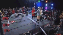 a man is standing in a boxing ring holding a rope
