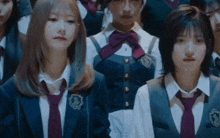 a group of girls in school uniforms and ties are standing together