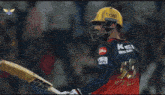 a cricket player wearing a helmet with boat on it