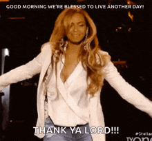 a woman in a white jacket is dancing on a stage and says thank ya lord .