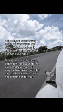 a person riding a motorcycle down a road with a quote in a foreign language on the bottom