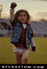 a little boy in a diaper is running on a field with nycrhythm.com written on the bottom