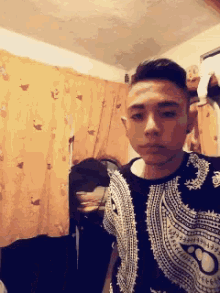 a young man taking a selfie in a bedroom