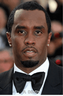 a close up of a man wearing a tuxedo and bow tie with p. diddy written below him