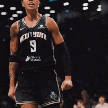 a female basketball player wearing a jersey that says new york