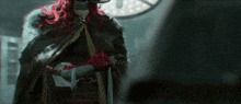 a man with red hair is standing in front of a clock and holding a sword