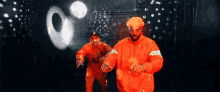 dancing brothers rapping flexing orange suits
