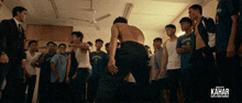 a group of young men are standing in a room and the word kahar is on the bottom