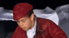 a man wearing a red hat and a red jacket has a viggle.ai watermark