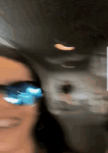 a blurry photo of a person wearing sunglasses
