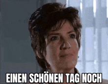 a close up of a woman 's face with the words einen schönen tag noch written on it .