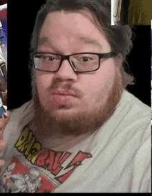 a man with glasses and a dragon ball z shirt on