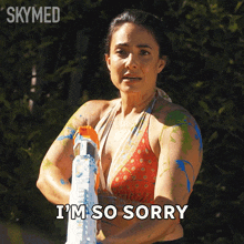 a woman in a bikini holds a water gun and says i 'm so sorry