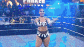 a woman in a wrestling ring with a sign that says parker in the background