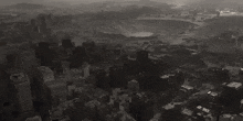 an aerial view of a city with a large lake in the background
