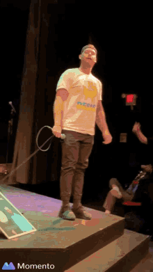 a man in a t-shirt that says rescue stands on a stage