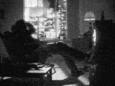 a man sits in a chair in front of a tv