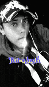 a black and white photo of a young man with the words terima kasih on the bottom right