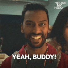 a man with a beard smiles and says yeah buddy