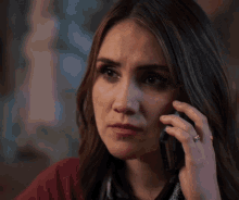 a woman talking on a cell phone with a ring on her finger
