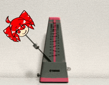 a gray and pink yamaha metronome with a red cat on it