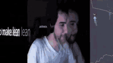 a man with a beard is playing a video game on a computer screen .