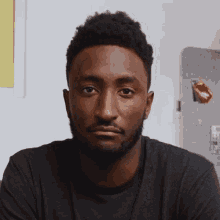 a man with a beard is looking at the camera