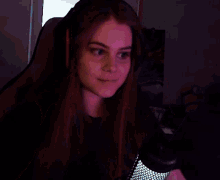 a girl with red nails is giving the middle finger while sitting in a chair .