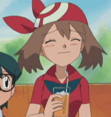 a cartoon girl with a red hat is drinking orange juice through a straw