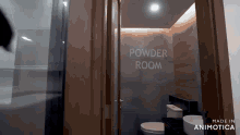 a bathroom with the words powder room on the wall above the toilet