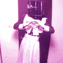 a person making a heart shape with their hands in front of a door