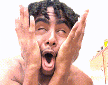 a shirtless man is making a funny face with his eyes closed