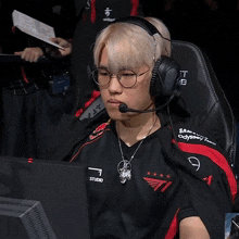 a man wearing headphones and a red bull jersey