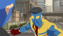 a man in a blue and yellow superhero costume is fighting another man