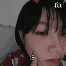 a close up of a woman 's face with the number 3 on her face