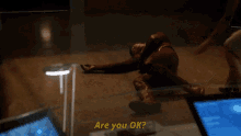 a man laying on the floor with the words " are you ok " below him