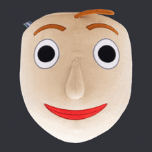 a stuffed toy that looks like a face with big eyes