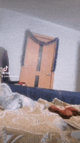 a tik tok video of a bedroom with a couch and a door