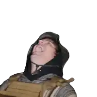 a man wearing a hoodie and a vest is laughing