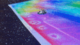 a video game character is driving a kart on a rainbow road