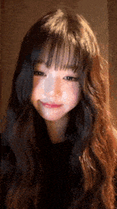 a close up of a girl with long hair and bangs making a funny face