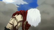 a man with white hair and a red cape is laying down
